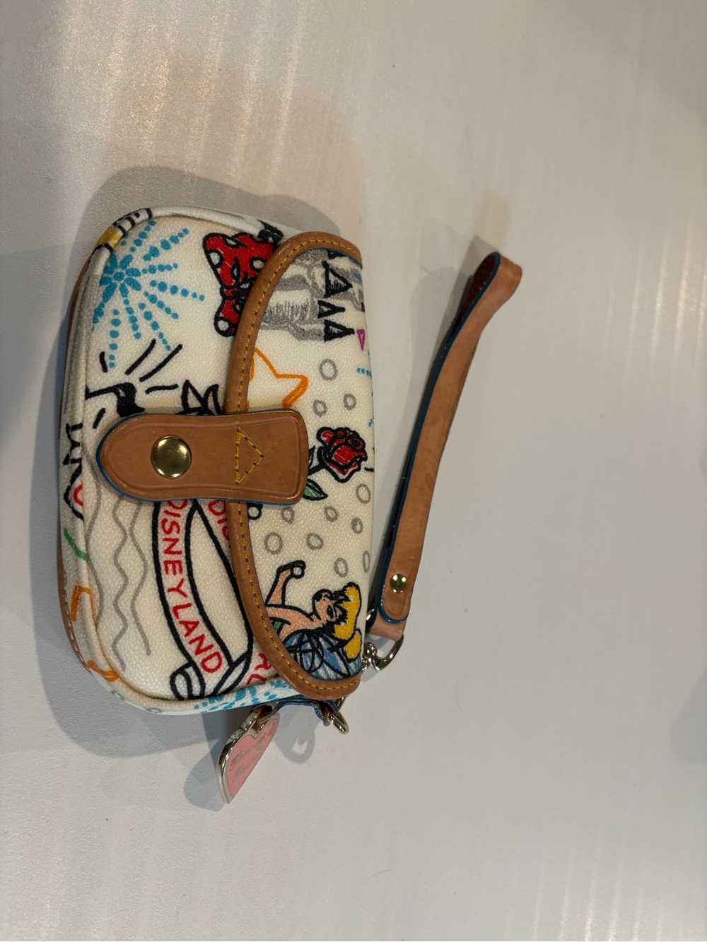 Dooney and Burke Disney Wristlet featuring various Disney images